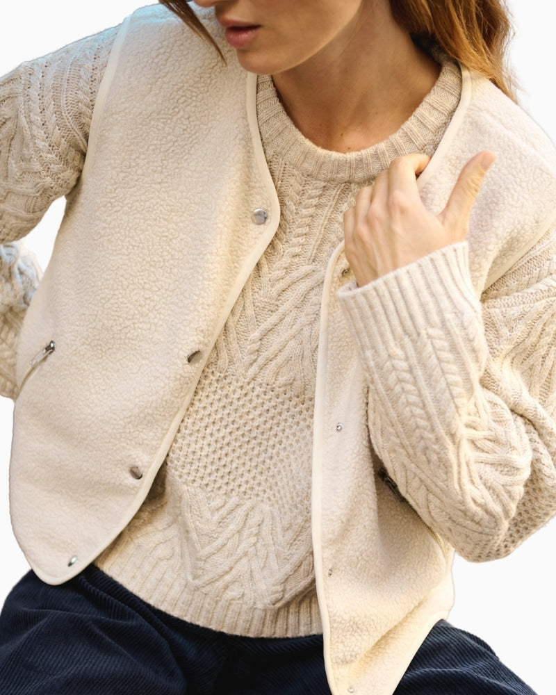 Close-up of snap-button front and pocket detail on teddy vest