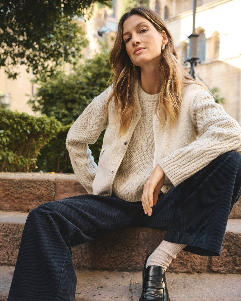 Model wearing beige Part Two waistcoat styled over striped long-sleeve tee