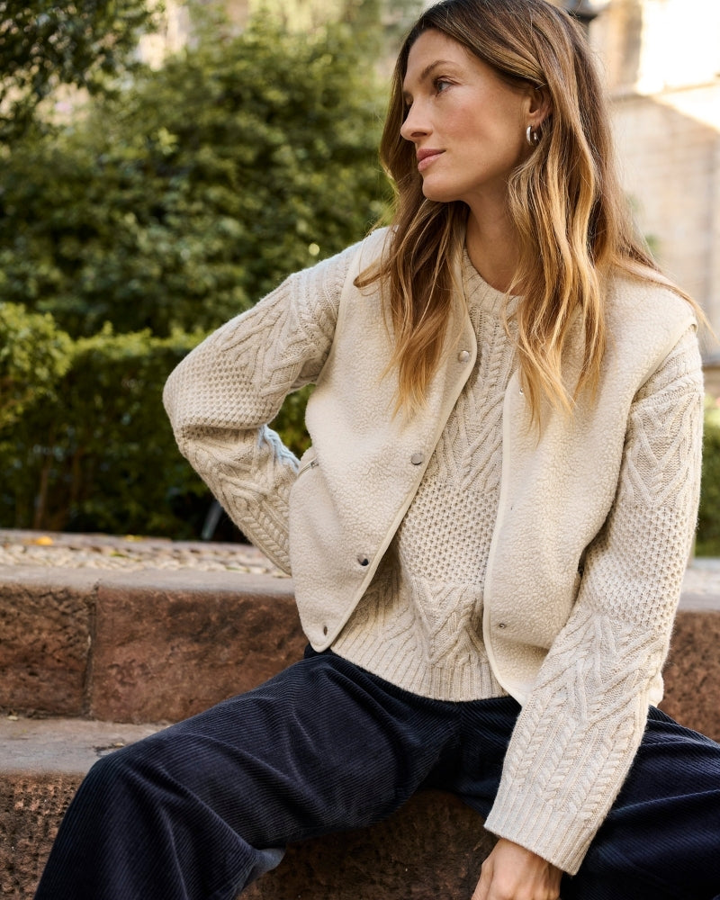 Model wearing beige Part Two waistcoat styled over striped long-sleeve tee