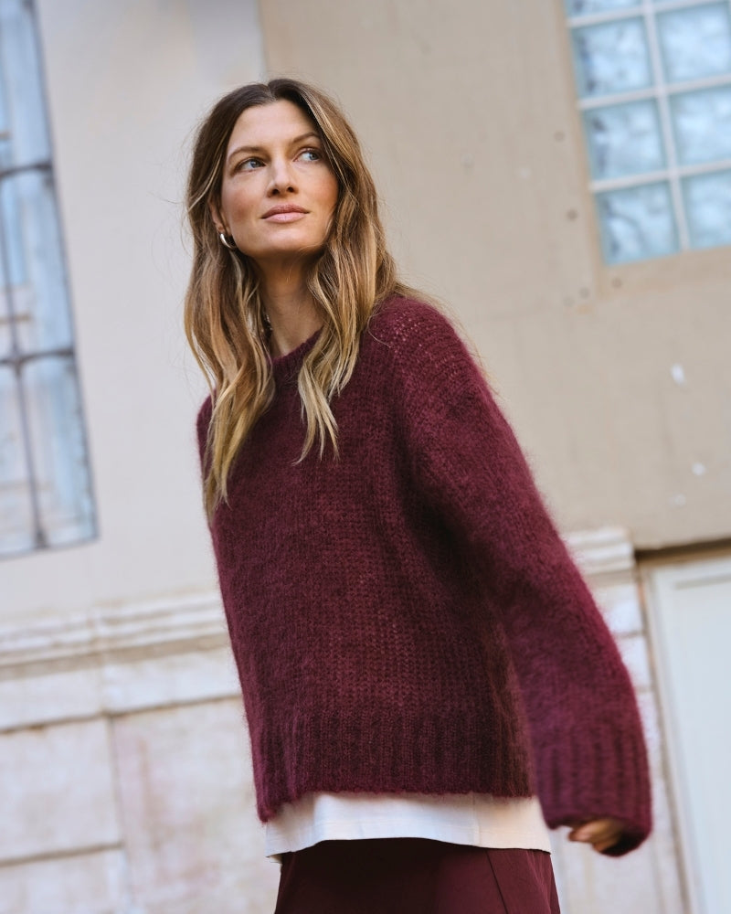 Side view of lightweight knit showing ribbed cuffs and soft texture