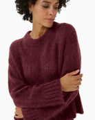 Close up of  Part Two burgundy jumper styled casually with jeans for everyday wear