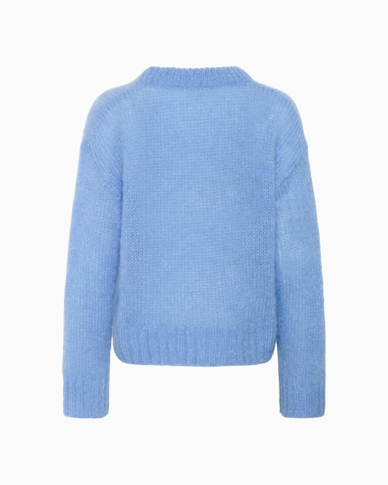 Back view of relaxed fit blue jumper with long sleeves and airy finish
