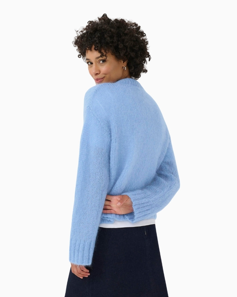 Back view of relaxed fit blue jumper with long sleeves and airy finish