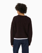 Back view of Sindy pullover with decorative button detail and soft wool texture