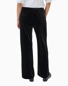 Back view of full-length black trousers with elasticated waistband
