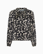 Front view of grey blouse with buttoned cuff and soft drape