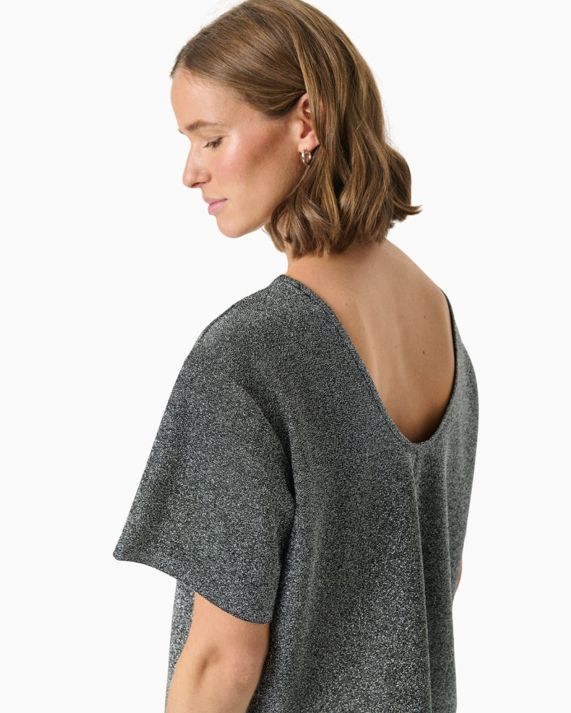 Close-up of metallic thread detail in soft stretch knit