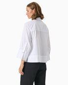 Side view of cropped blouse with relaxed fit and ¾-length wide sleeves