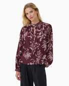 Model wearing Part Two Shiroma blouse with long sleeves and buttoned neckline