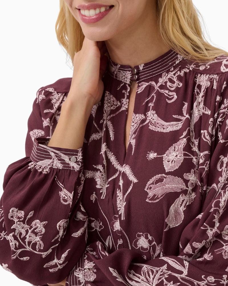 Close-up of fabric in tawny port with tonal botanical pattern