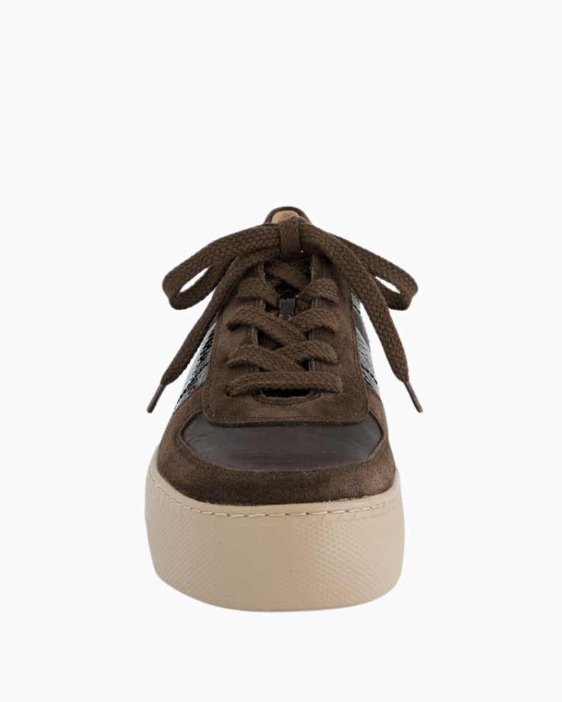 Close-up of crumpled-look patent leather detail on sneakers