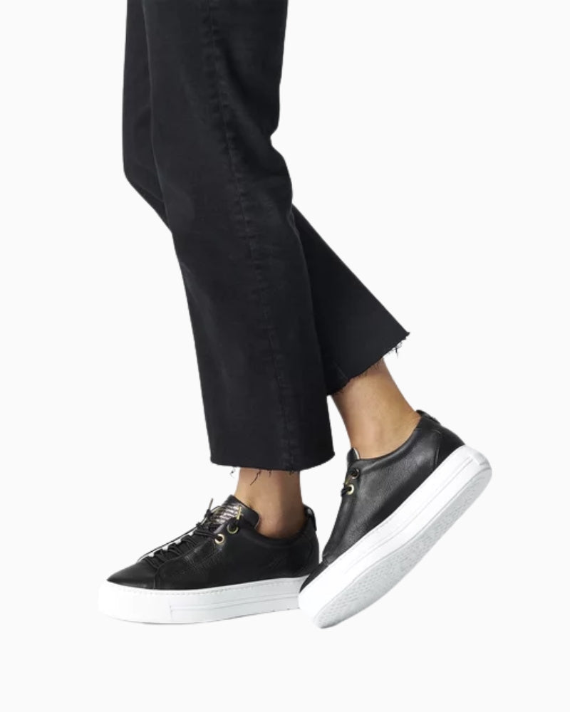 Model styling black Paul Green trainers with smart trousers