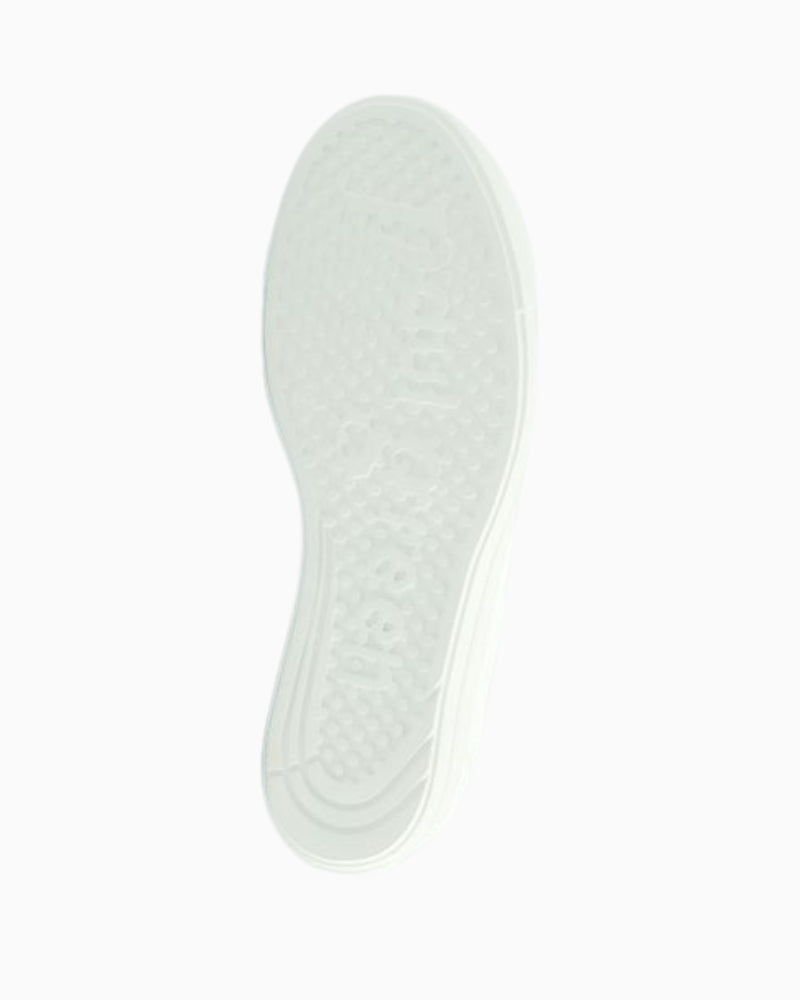 Flexible rubber sole on white leather sneaker for all-day comfort