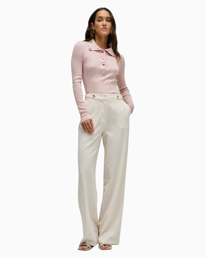 Woman wearing Salsa pink polo knit with gold buttons – Áines Boutique