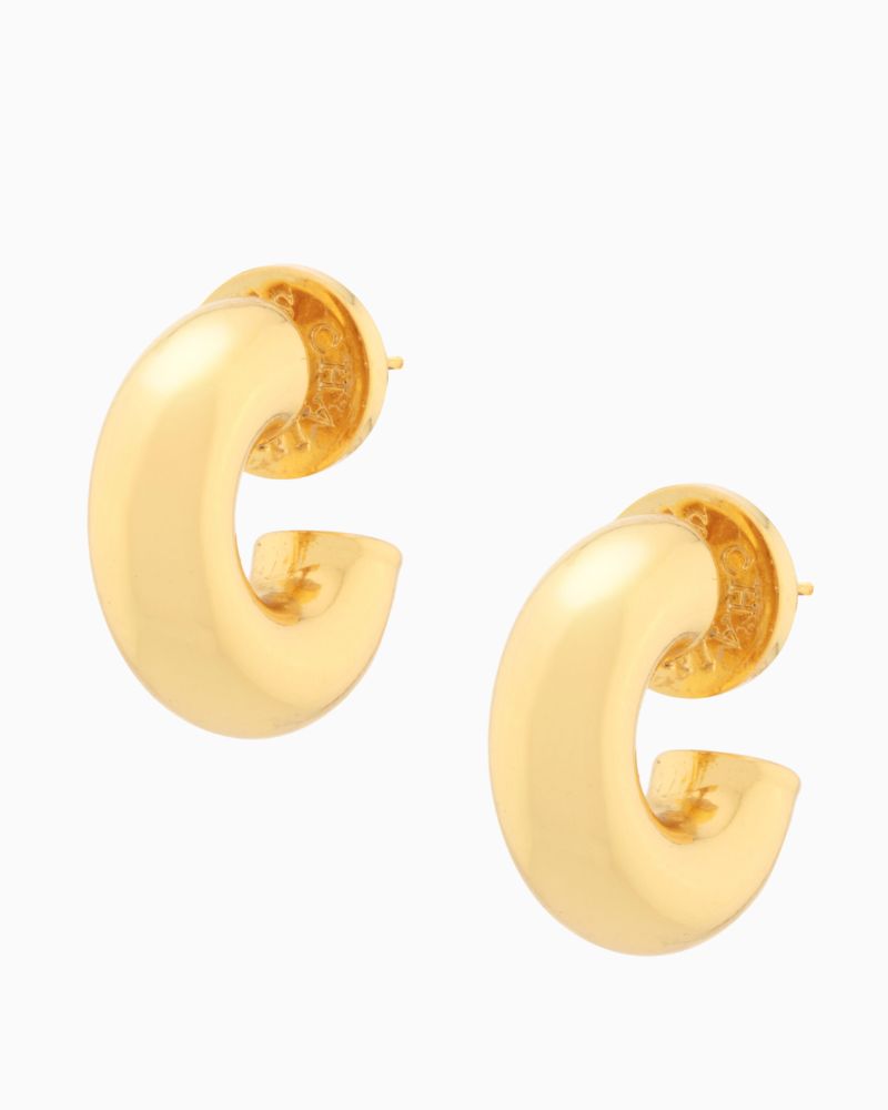 Pair of chubby gold huggie earrings shown with linen drawstring pouch