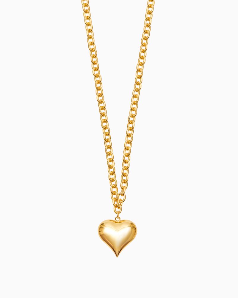 Close-up of large gold heart pendant with high shine finish