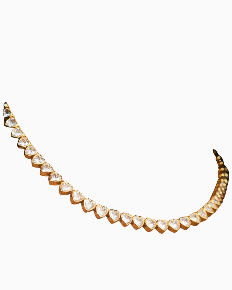 Close-up of heart-shaped cubic zirconia tennis necklace with freshwater pearl detail