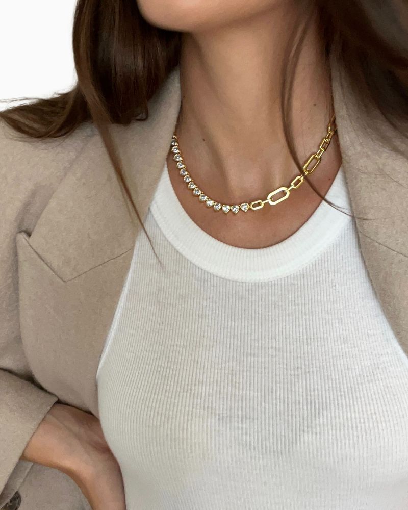 Gold plated hearts tennis necklace shown with linen drawstring pouch