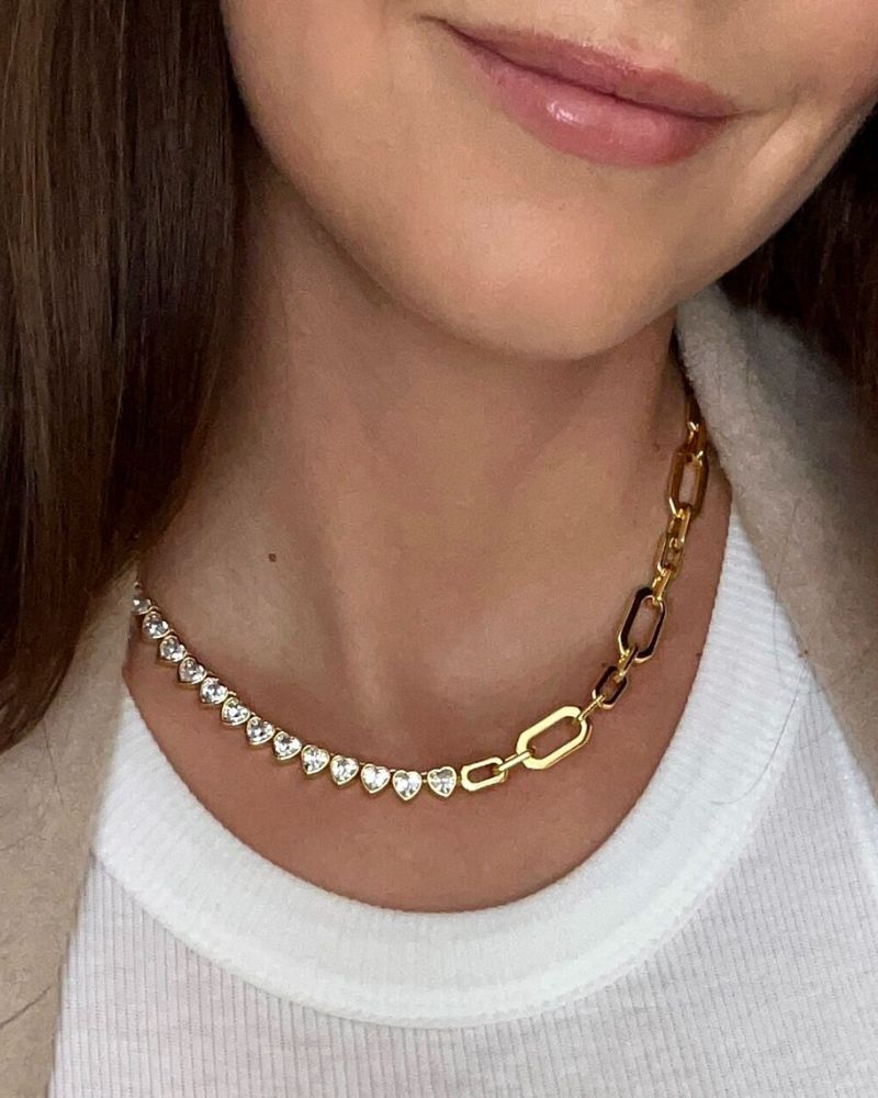 Close-up of signature gold chain with cubic zirconia heart details
