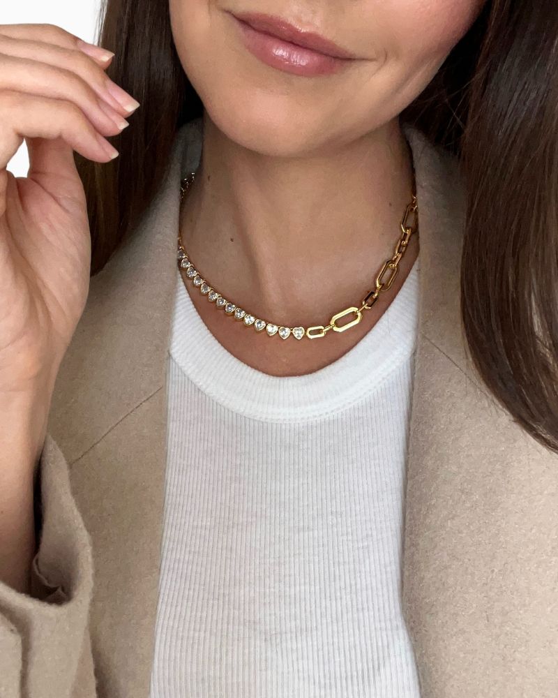 Gold plated hearts tennis necklace shown with linen drawstring pouch