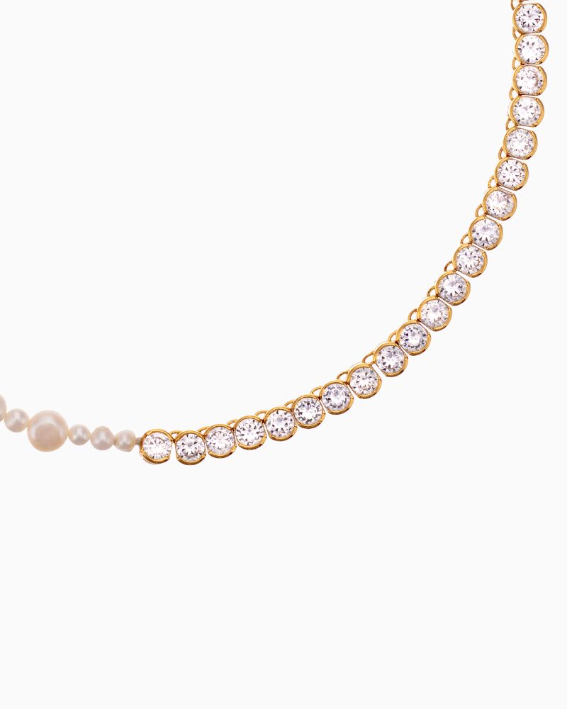 Close-up of pearl and cubic zirconia choker necklace with gold plated detail