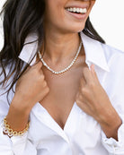 Freshwater pearl and cubic zirconia necklace shown with linen drawstring pouch