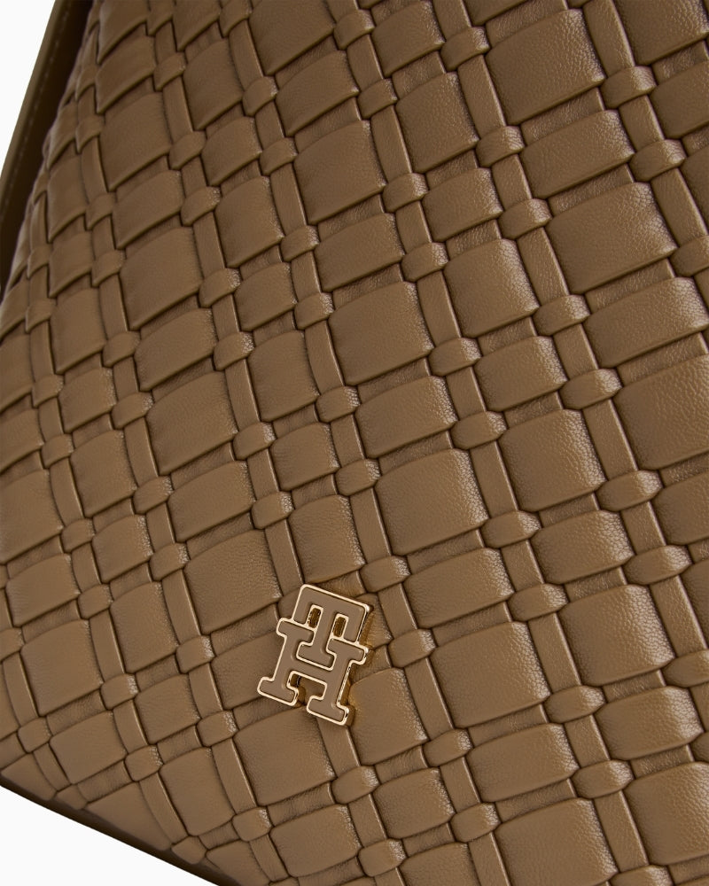 Close-up of braided strap detail on black faux leather bag