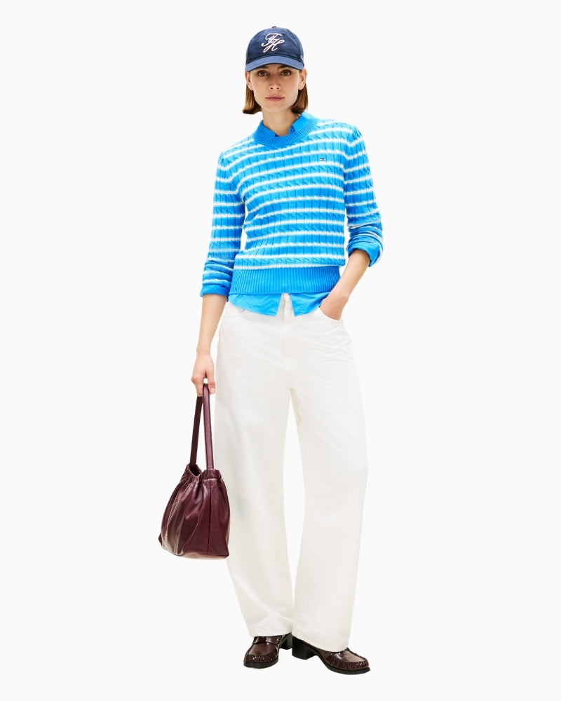 Model styling blue striped jumper with jeans for casual wear