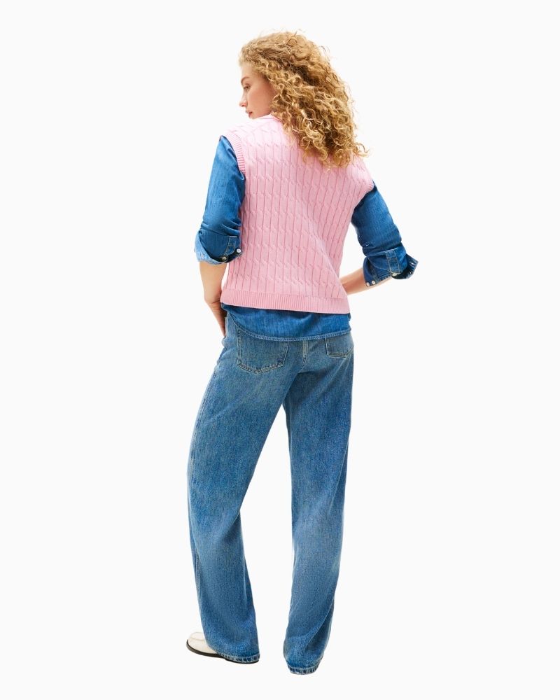 Polo-style sleeveless jumper styled with neutral trousers