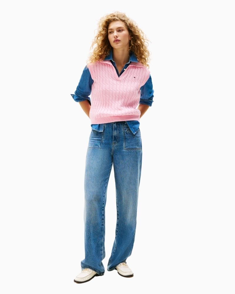 Front view of cable knit vest with ribbed hem and embroidered logo