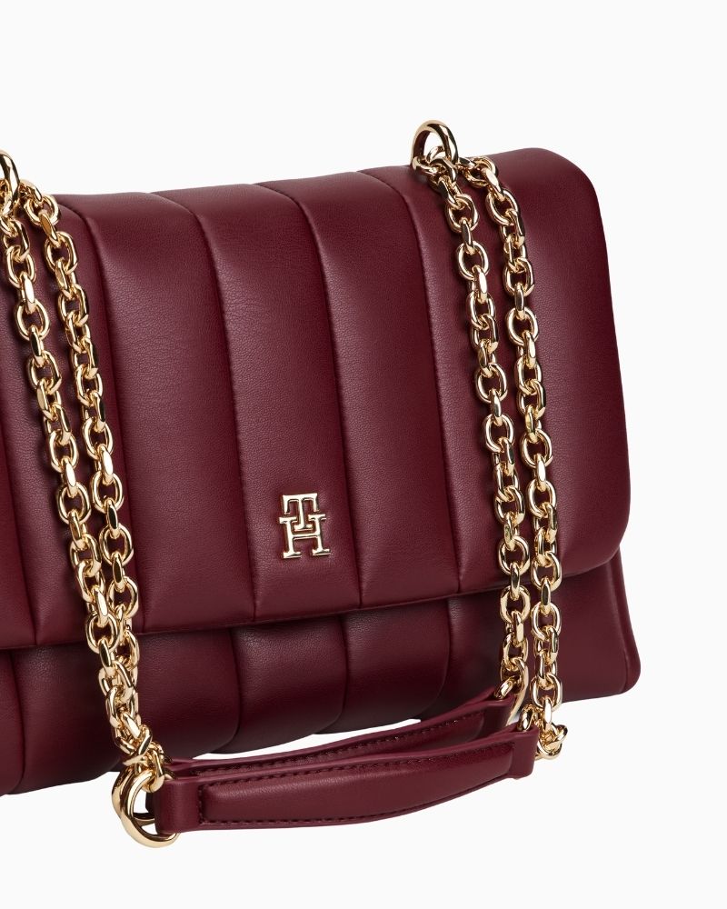 Close up of Tommy Hilfiger padded black crossbody bag with chain strap and monogram plaque
