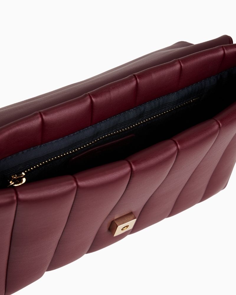 Interior of TH chain bag showing main compartment and zipped pocket