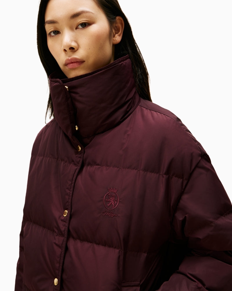 Close-up of Tommy Hilfiger crest detail on burgundy padded jacket
