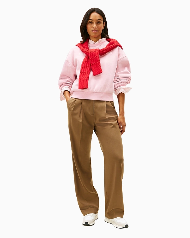 Model wearing crew neck sweatshirt styled casually with joggers