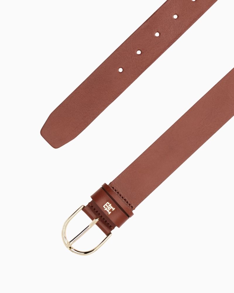 Close-up of TH belt in brown leather showing smooth finish and buckle detail