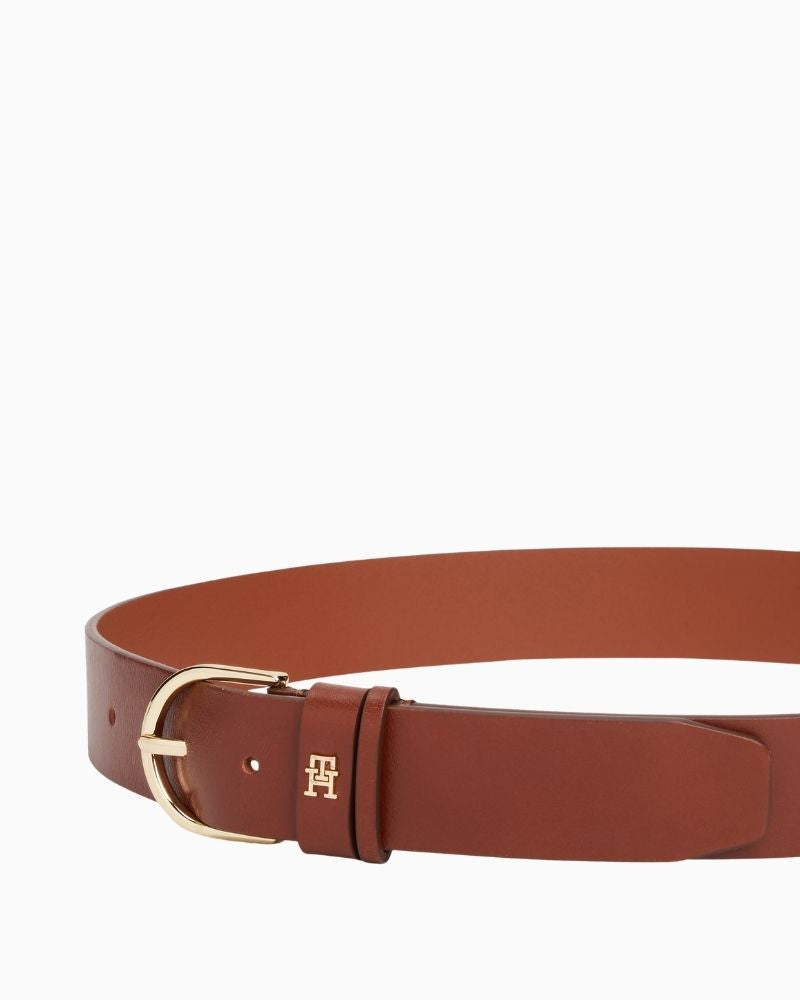 Close-up of TH belt in brown leather showing smooth finish and buckle detail