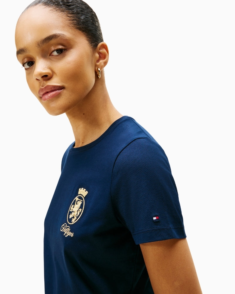 Close-up of gold crest logo on Tommy Hilfiger tee