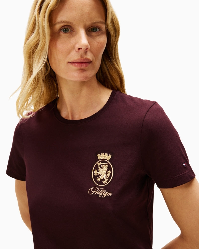 Close-up of embroidered gold crest on chest