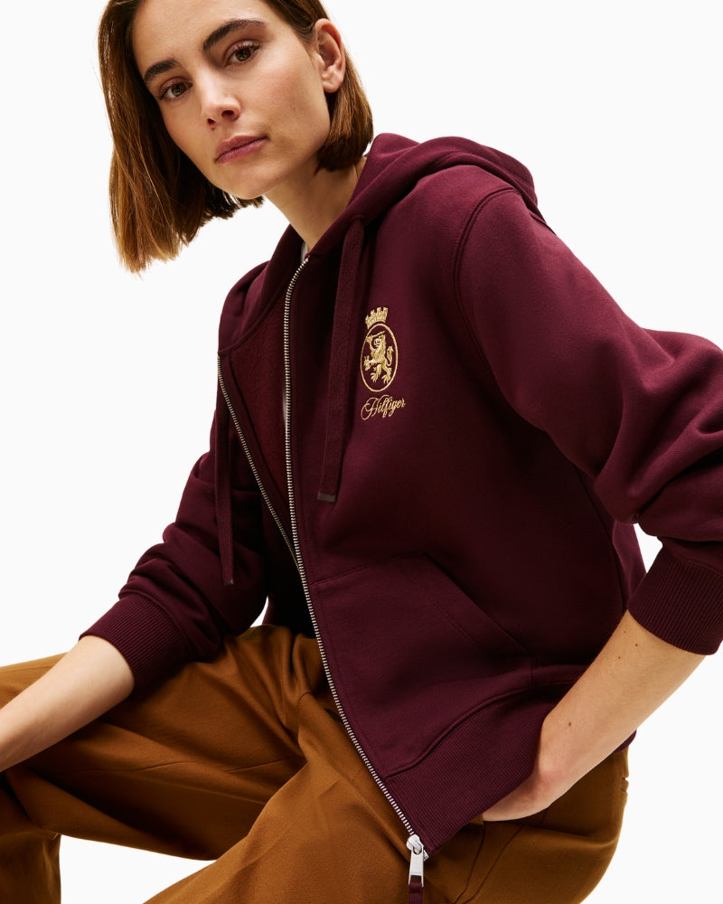 Close-up of embroidered gold crest on Tommy Hilfiger jacket