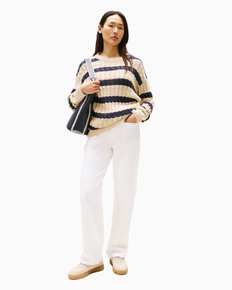 Front view of relaxed fit jeans with slit pockets and zip-button closure