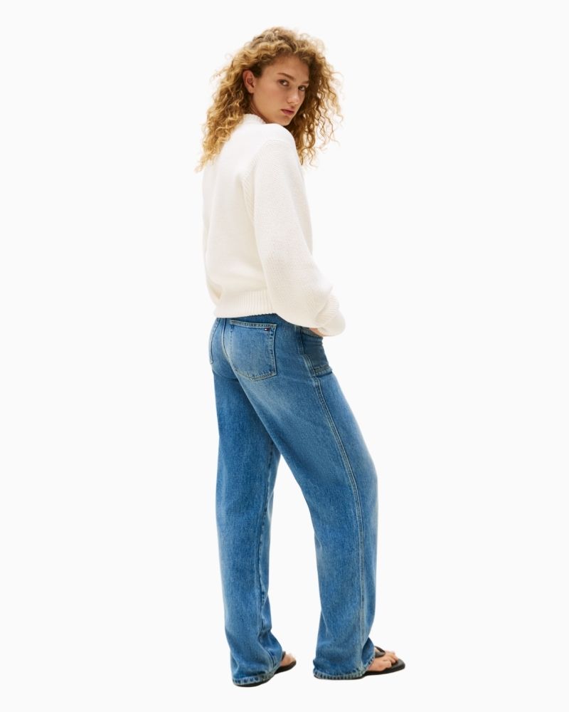 Side view of Model wearing relaxed cotton cardigan with Tommy branding on sleeve