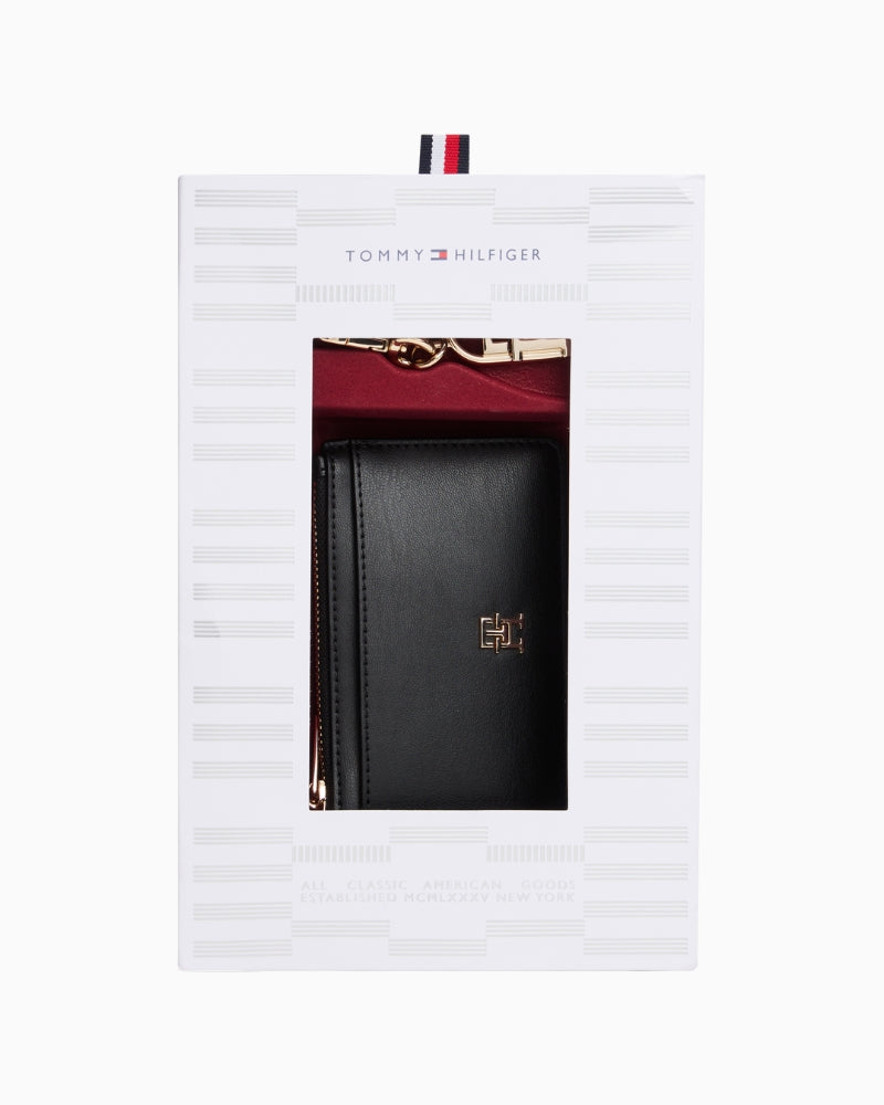 Black long card holder with attached charm bag in faux leather