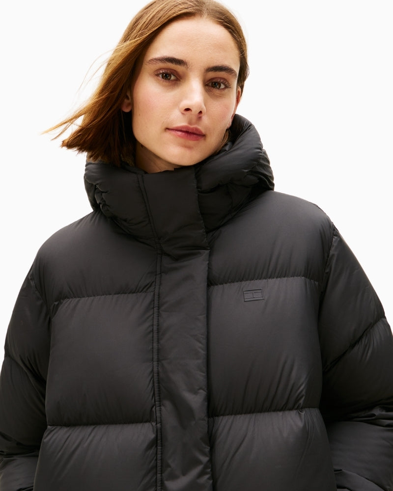 Close-up of quilted detail and high collar on black down maxi coat