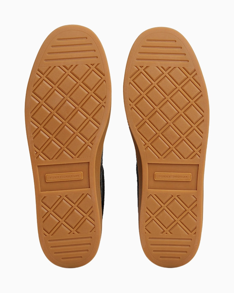 Back view of trainers with metallic flag logo embossed on heel