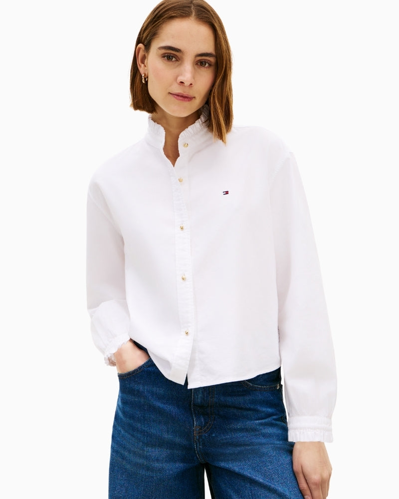 Woman wearing white Tommy Hilfiger oxford crop ruffle shirt front view – Áines Boutique
