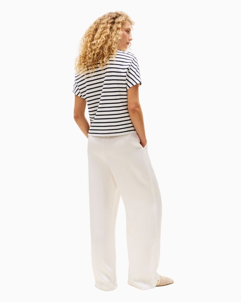 Back view of feminine polo with dropped shoulders and sleeve logo