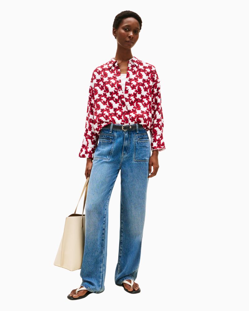 Model wearing relaxed shirt tucked into trousers for a smart casual look