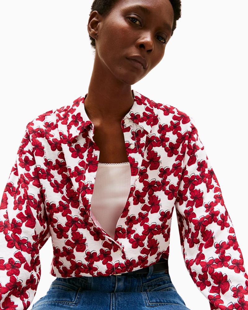 Close-up of Tommy Hilfiger metal flag branding on cuff with adjustable button closure