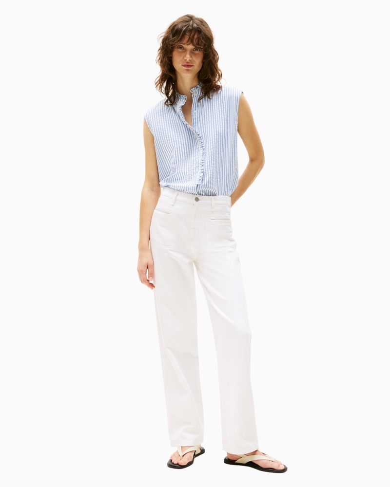 Feminine blue shirt styled with white jeans for a fresh summer look