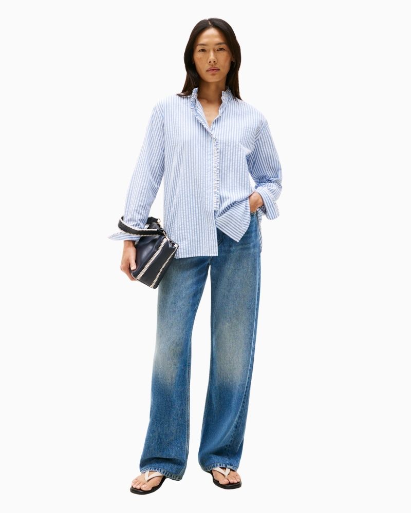 Feminine blue shirt styled with white jeans for a fresh summer look